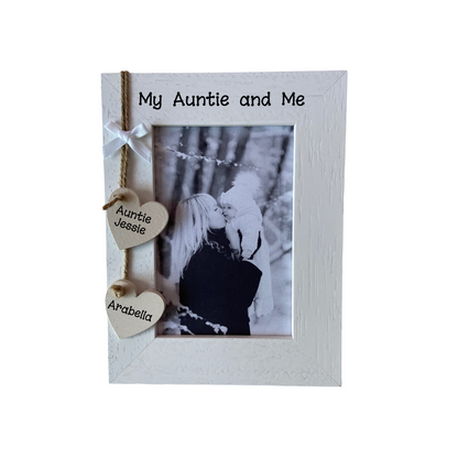 Image shows an auntie photo frame, it incudes two hanging hearts with the aunties name and the niece or nephews name too, also a small white bow above the hearts. Can also add bling if wanted.