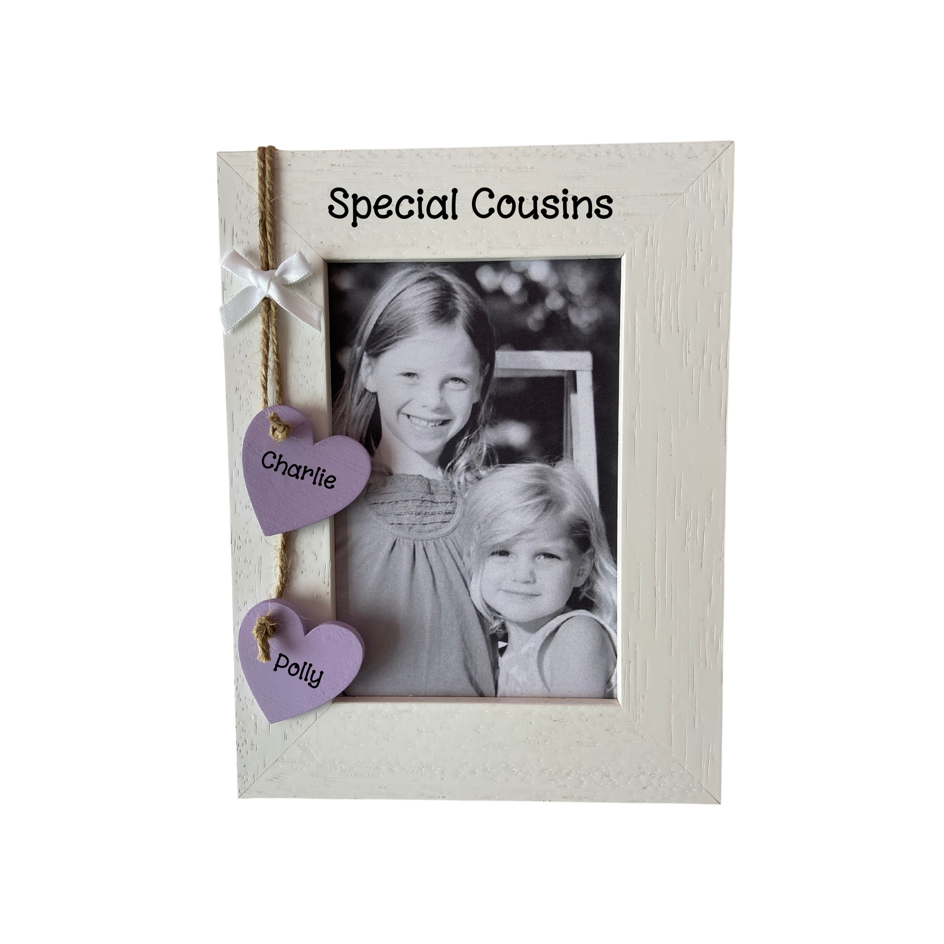 Image shows a special cousins photo frame, including two hanging hearts with the names of cousins, also a white bow sat above and bling if wanted.