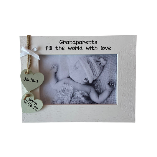 Image shows newborn baby photo frame for grandparent's, includes two hanging hearts with baby's name and date of birth, also a small white bow placed above, bling can be added