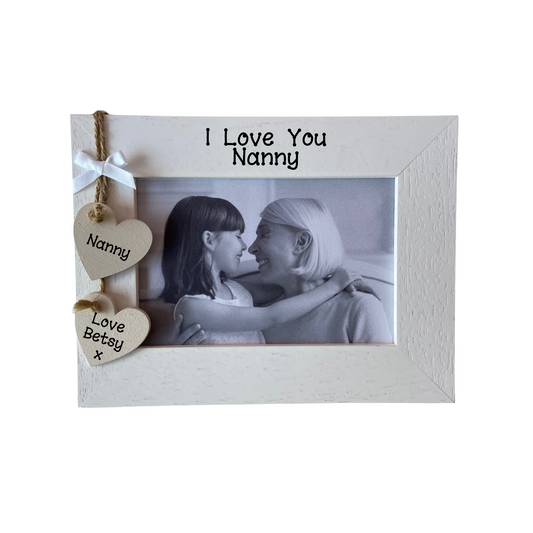 Image shows a nanny photo frame, includes two hanging hearts with nanny and the name of grandchild, also a small white bow and bling if wanted.