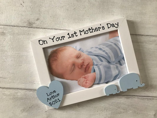 Image shows a 1st mothers day photo frame, includes a mummy and baby elephant as well as a wooden heart with a name and year.