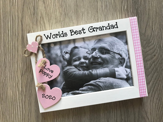 Image shows worlds best grandad wooden photo frame, attached is two wooden hearts with grandchild's name and year, down the side gingham is attached.